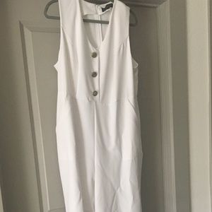 Eloquii white jumpsuit with gold buttons.